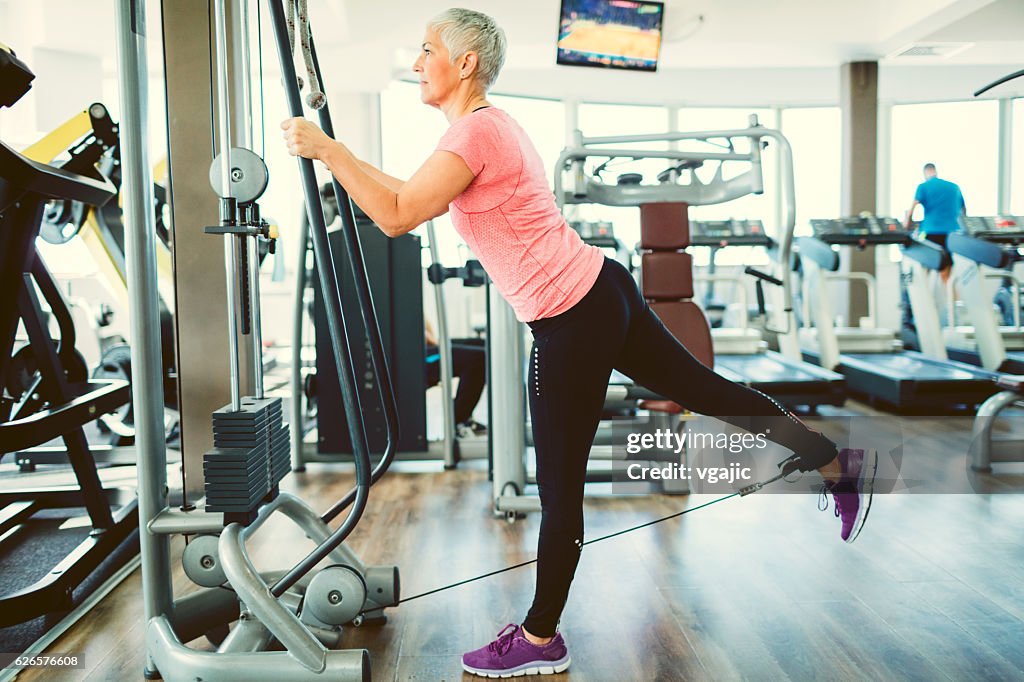 Mujer madura haciendo ejercicio en gimnasio.
