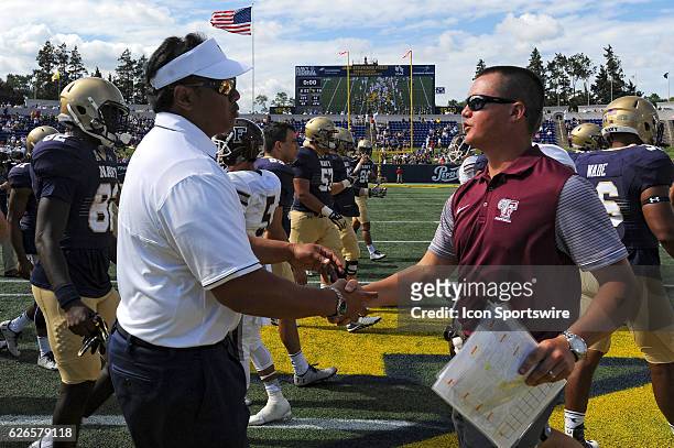 Navy Midshipmen head coach Ken Niumataolo shakes hands with Fordham Rams head coach Andrew Breiner at the Navy Marine Corps Stadium in Annapolis, MD....