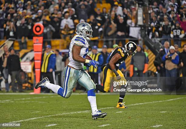 Running back Ezekiel Elliott of the Dallas Cowboys scores on a 32-yard touchdown run as he is pursued by safety Mike Mitchell of the Pittsburgh...