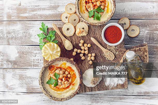 hummus topped with whole chickpeas and olive oil. - hummus stock pictures, royalty-free photos & images