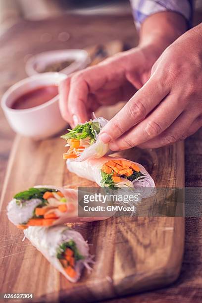 preparing homemade spring rolls with fresh vegetables - spring rolls stock pictures, royalty-free photos & images
