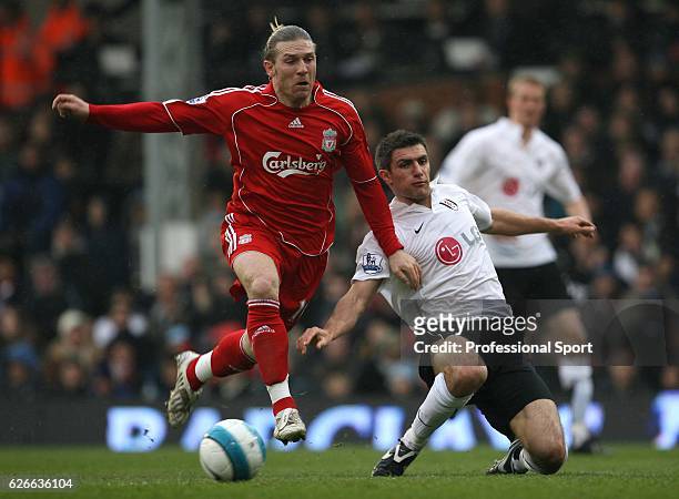 Andriy Voronin of Liverpool and David Healy of Fulham tussle for the ball during the Barclays Premier League match between Fulham and Liverpool at...