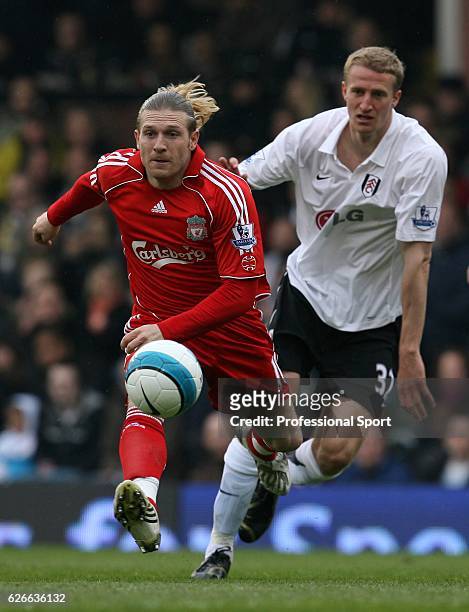 Andriy Voronin of Liverpool gets away from Brede Hangeland of Fulham during the Barclays Premier League match between Fulham and Liverpool at Craven...