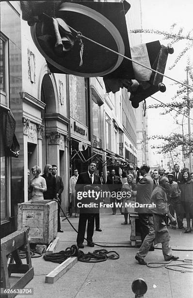 American artist David Smith supervising the installation of his sculpture at the Marlborough-Gerson Gallery, 41 East 57th Street, New York, New York,...
