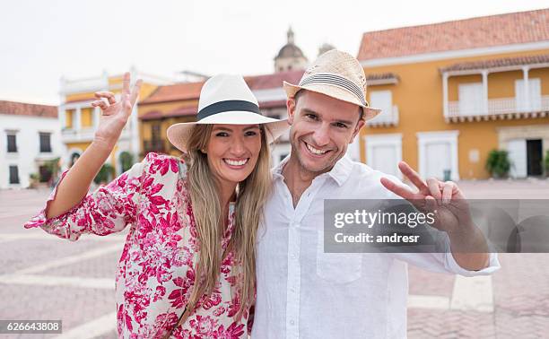 happy couple having fun in their holidays - happy holidays around the world stock pictures, royalty-free photos & images