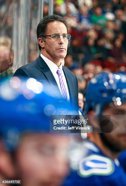 Assistant coach Doug Lidster of the Vancouver Canucks looks on from the bench during their NHL game against the Arizona Coyotes at Rogers Arena...