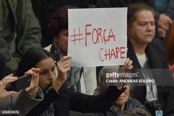 Woman attending Pope Francis weekly audience holds a placard reading "Força Chape" in memory of the players of Chapecoense Real football team, at the...