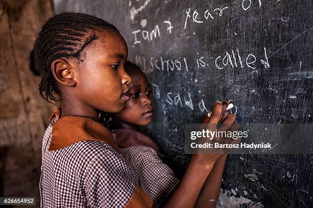 african little girls are learning english language, orphanage in kenya - african stock pictures, royalty-free photos & images