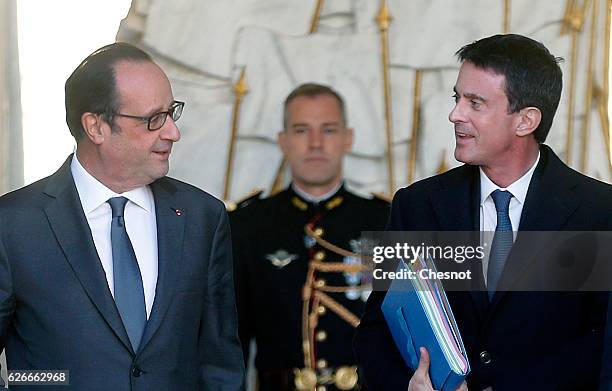 French President, Francois Hollande talks with French Prime minister, Manuel Valls after the weekly cabinet meeting at the Elysee Presidential Palace...