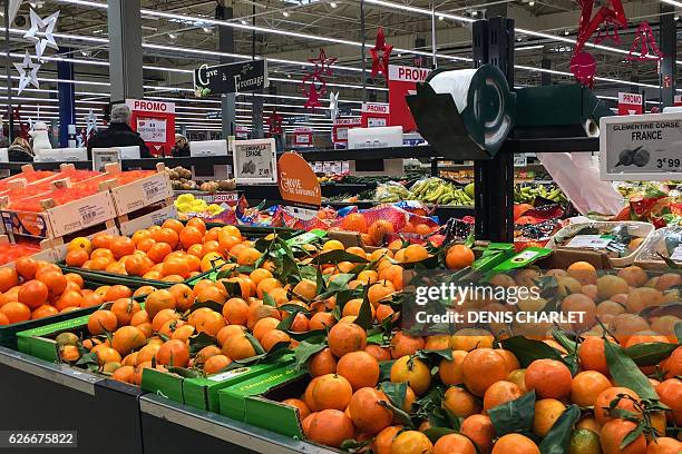 Stall of clemetine is pictured as people shop for grocery on November 30, 2016 in a supermarket of Lille, northern France. / AFP / DENIS CHARLET