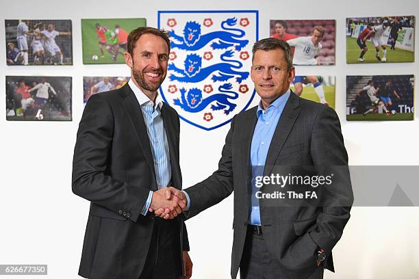 In this handout image provided by the FA, FA Chief Executive Martin Glenn shakes hands with Gareth Southgate as he is announced as new England...