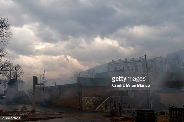 Smoke fills the air and surrounds businesses and resorts in the wake of a wildfire November 30, 2016 in downtown Gatlinburg, Tennessee. Thousands of...