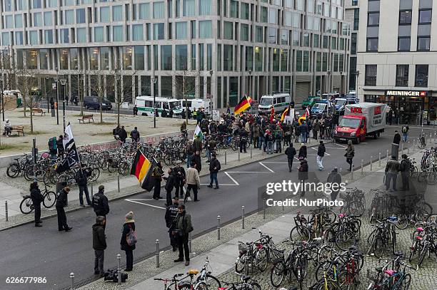 Supporters of the Pegida movement, in Berlin known by its local chapter as Baergida, carry flags and shoot anti-government slogan on November 26,...