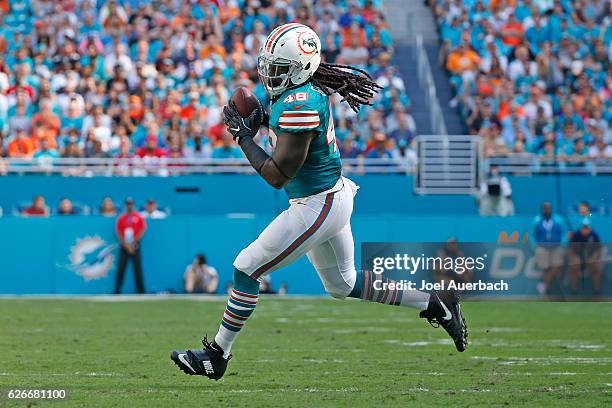 Marqueis Gray of the Miami Dolphins runs with the ball against the San Francisco 49ers on November 27, 2016 at Hard Rock Stadium in Miami Gardens,...