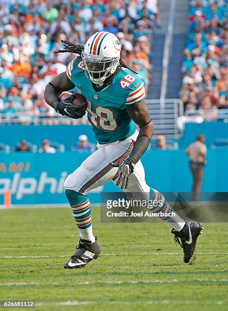 Marqueis Gray of the Miami Dolphins runs with the ball against the San Francisco 49ers on November 27, 2016 at Hard Rock Stadium in Miami Gardens,...