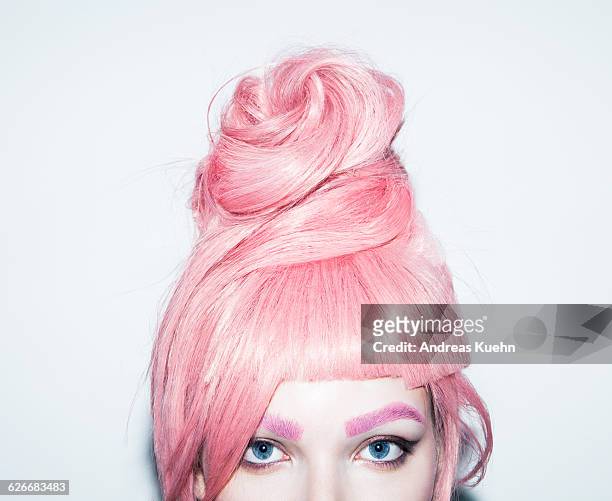 young woman with pink hair wig in an updo, crop. - stile di capelli foto e immagini stock