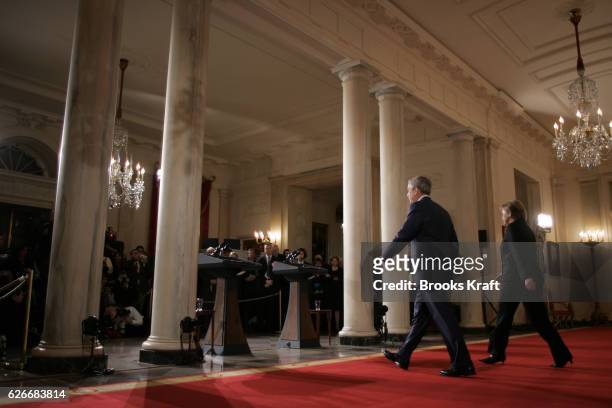 President George W Bush and German Chancellor Angela Merkel arrive for a joint press conference in the Cross Hall of the White House in Washington.
