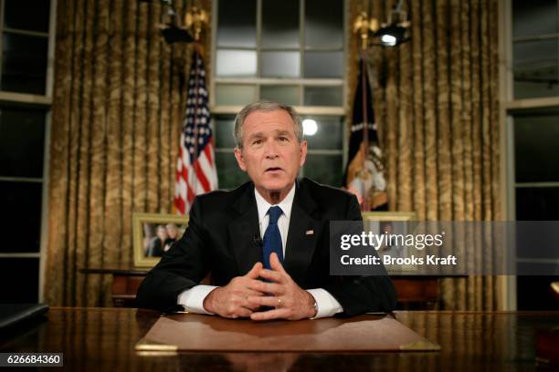 President George W. Bush pauses in the Oval Office after addressing the nation on his strategy for Iraq, at the White House in Washington, DC. Bush...