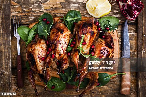 homemade sticky roast quail served with  green salad and pomegranate seeds - quail bird stock pictures, royalty-free photos & images