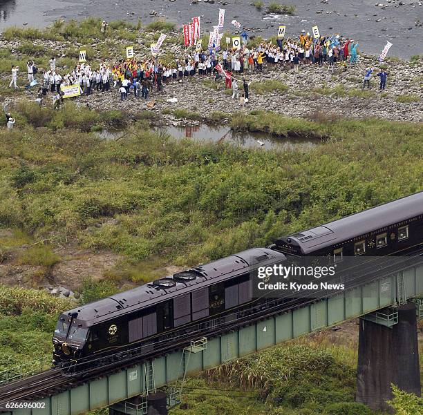 Japan - Photo taken from a Kyodo News helicopter shows the "Seven Stars in Kyushu" train running near the border between Fukuoka and Oita prefectures...