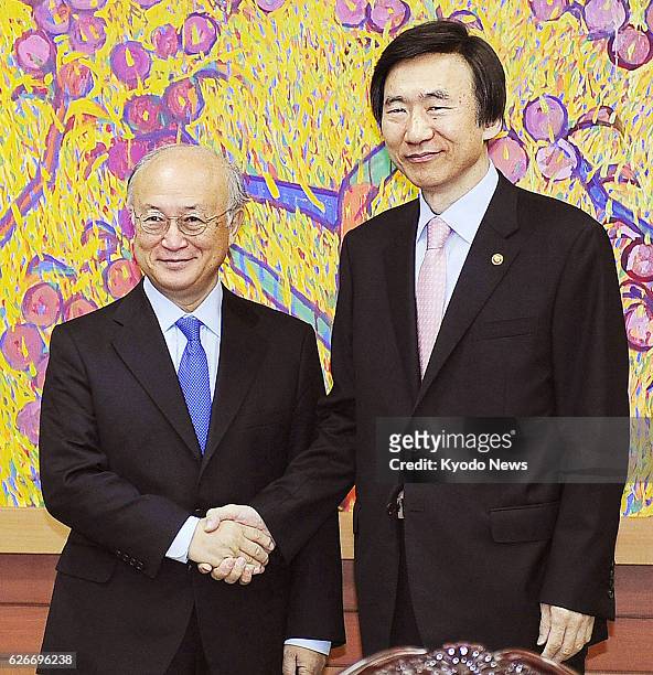 South Korea - International Atomic Energy Agency Director General Yukiya Amano and South Korean Foreign Minister Yun Byung Se shake hands before...