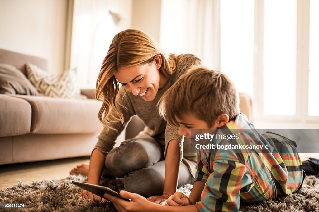 Mother and son with digital tablet