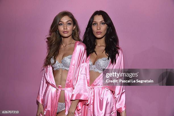 Gigi Hadid and Bella Hadid pose backstage prior to the Victoria's Secret Fashion Show on November 30, 2016 in Paris, France.