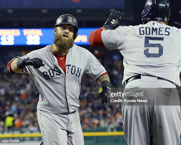 United States - The Boston Red Sox's Mike Napoli is greeted by next batter Jonny Gomes after hitting a solo homer during the second inning of Game 5...