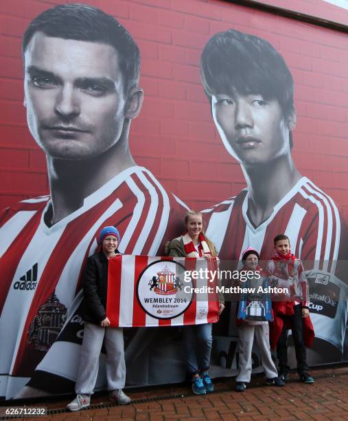 Sunderland fans have their photo taken infront of a picture of Adam Johnson and Ki Sung-Yong of Sunderland