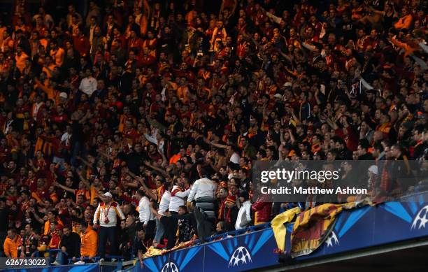 Galatasaray fans stand as they sing chants