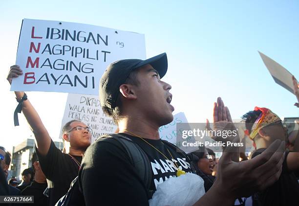 Filipino protesters participate in a rally at the People Power Monument in EDSA on Wednesday against the heros burial of former dictator Ferdinand...