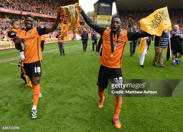 Bakary Sako of Wolverhampton Wanderers and Nouha Dicko of Wolverhampton Wanderers celebrate winning the league One title with the trophy