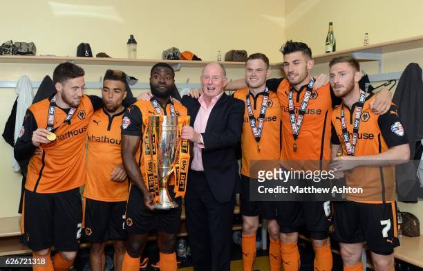 Steve Morgan the owner / chairman of Wolverhampton Wanderers celebrates with the players after winning the league One title with the trophy