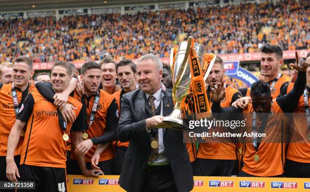 Kenny Jackett the head coach / manager of Wolverhampton Wanderers celebrates winning the league One title with the trophy