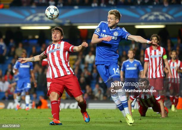 Cristian Rodriguez of Atletico Madrid and Andre Schurrle of Chelsea