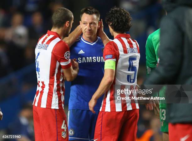 Dejected John Terry of Chelsea is consoled by Mario Suarez and Tiago of Atletico Madrid at the end of the match