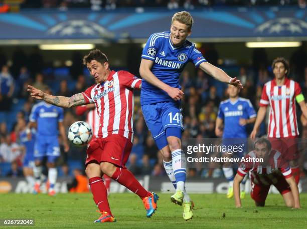 Cristian Rodriguez of Atletico Madrid and Andre Schurrle of Chelsea