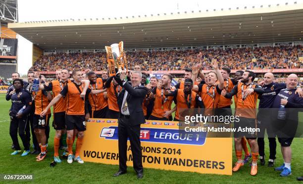 Kenny Jackett the head coach / manager of Wolverhampton Wanderers celebrates winning the league One title with the trophy