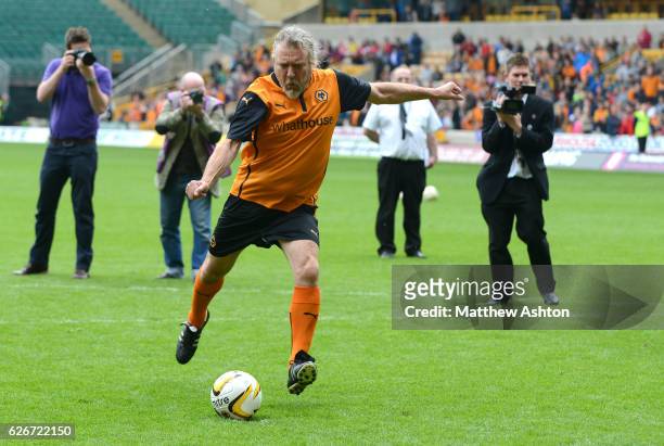 Robert Plant former singer of Led Zeppelin takes part in a penalty shoot out against Jez Moxey the CEO of Wolverhampton Wanderers at half time during...
