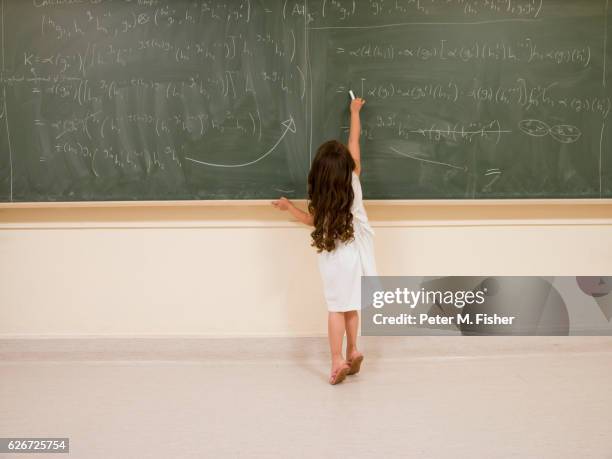 child prodigy writing on blackboard - child prodigy stock pictures, royalty-free photos & images