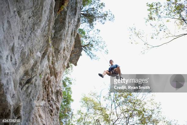 man repelling down cliff - chalk bag stock pictures, royalty-free photos & images