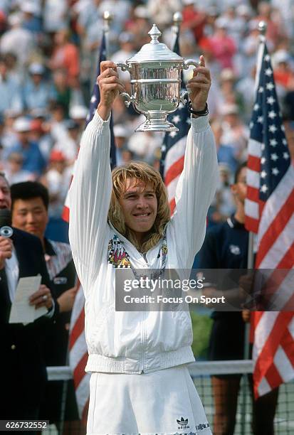 Tennis player Steffi Graf of Germany holds up the trophy after she defeated Martina Navratilova 3"u20136, 7"u20135, 6"u20131 in the finals of the...