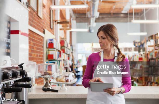 bakery owner using tablet pc - waiter using digital tablet stock pictures, royalty-free photos & images