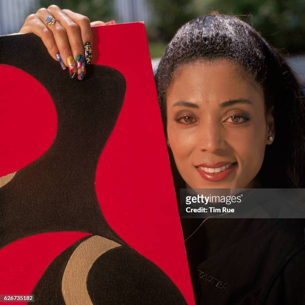 Former Olympic gold medalist Florence Griffith "Flojo" Joyner poses with her own painting in the backyard of her former home. Joyner died in 1998...