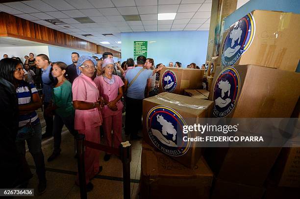 Staff of the Dr. Jose Gregorio Hernandez Hospital stand next to boxes with donations delivered by opposition members at Catia neighbourhood in...