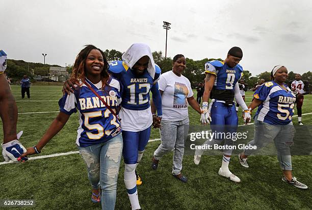 Odin Lloyd' sister's Olivia, at left, and Shaquila Thibou, at far right, both wearing his former Bandits jersey, join with Bandits players and...