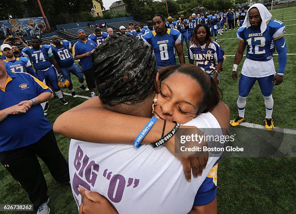 Odin Lloyd's mother Ursula Ward, back to camera, and girlfriend, Shaneah Jenkins, share an embrace during a pre-game ceremony honoring Lloyd on Jun....