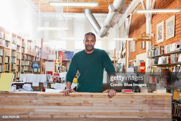 portrait of man in room full of books - book store owner stock pictures, royalty-free photos & images
