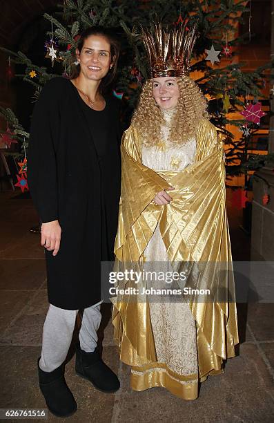 Julia Goerges , German ATP tennis player and actress Barbara Otto, dressed as 'Nuremberg Christkind' pose at town hall near Nuremberg Christmas...