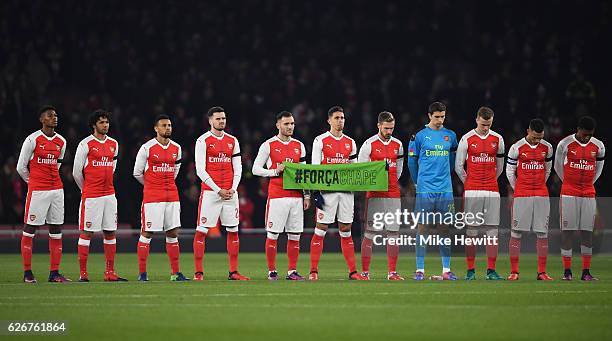 The Arsenal team observe a minutes silence ahead of the EFL Cup quarter final match between Arsenal and Southampton at the Emirates Stadium on...